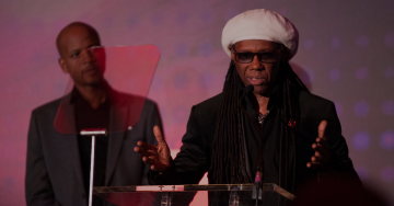 Two men speaking at a conference Two men speaking at a conference